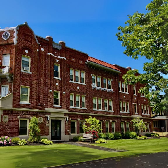 a large red brick building with a clock tower