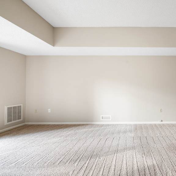 a large empty room with a carpeted floor and white walls.at atrium in the village, ohio, 44122