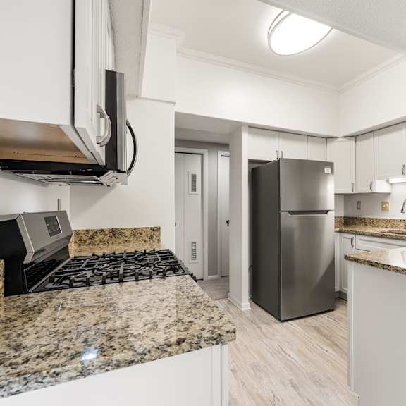 a kitchen with granite countertops and stainless steel appliances.at atrium in the village, beachwood, oh 44122