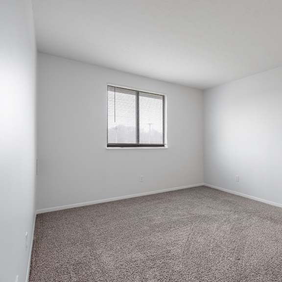 carpeted bedroom with window at integrity medina apartments, medina, 44256