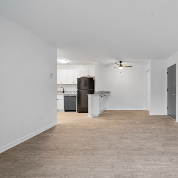 open living and dining area with entryway on right.
