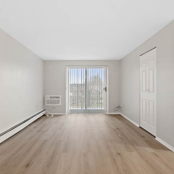 living room with ash wood floors and sliding door to balcony.