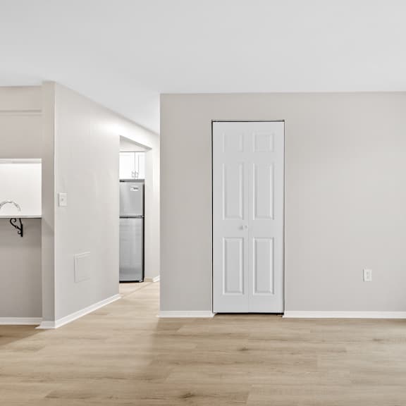living room with ash wood flooring, a closet, and a sliding door to the balcony.