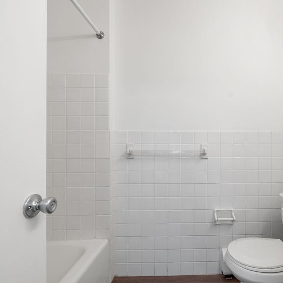 updated wynwood bathroom featuring all white counters and new bathtub.