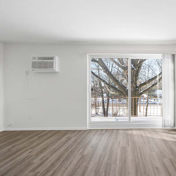 updated wynwood living room with sliding glass door to balcony.