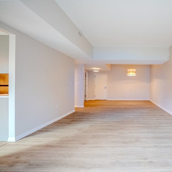 a long, empty hallway with light wood flooring and white walls t atrium in the village, beachwood, oh 44122