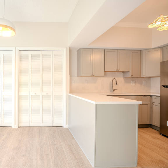 a kitchen with a white island and wooden floors t atrium in the village, 44122