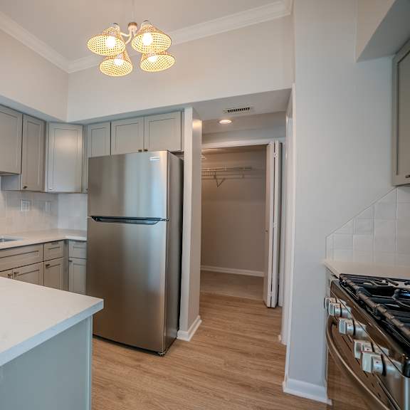 a kitchen with a refrigerator, stove, and cabinets t atrium in the village, beachwood