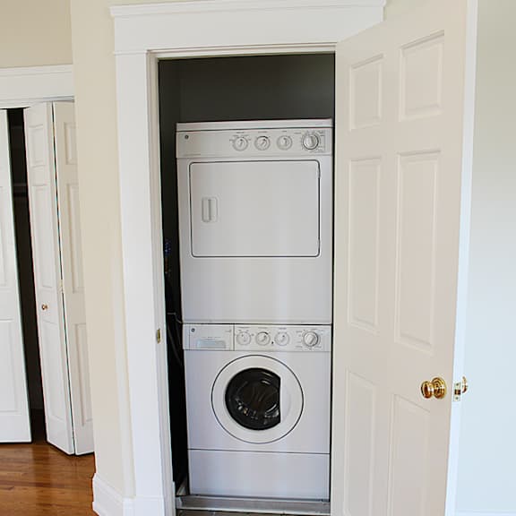 a small closet with a washing machine in it