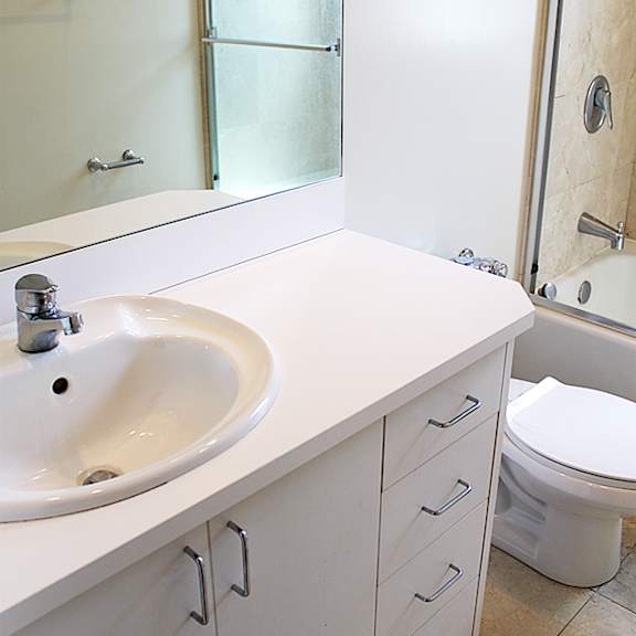 a bathroom with a sink and a toilet and a mirror