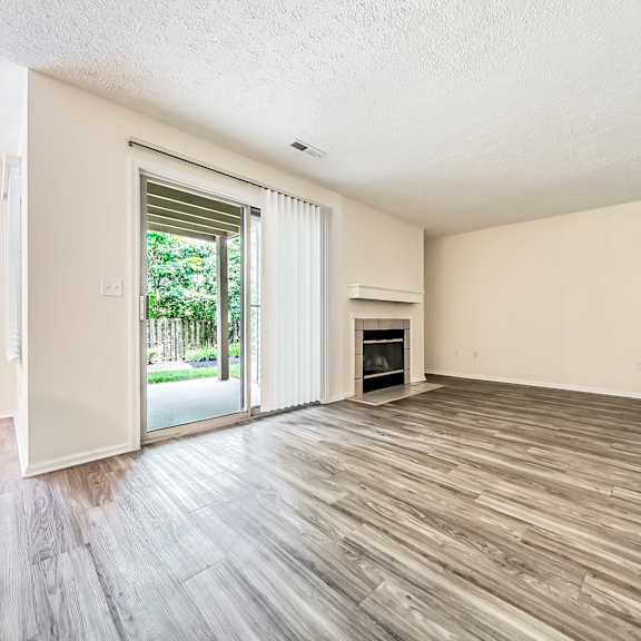 updated living room with plank-style flooring at hunt club apartments, ohio