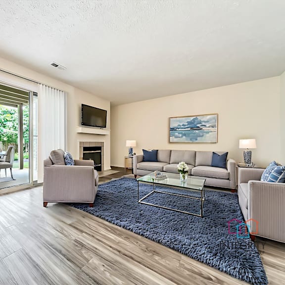 updated living room with plank-style flooring and example furnishings at hunt club apartments, copley