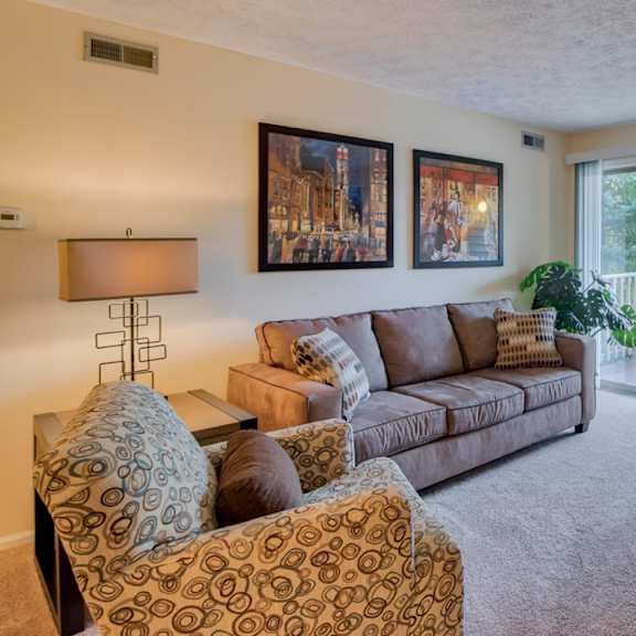 furnished carpeted living room at hunt club apartments, copley, oh