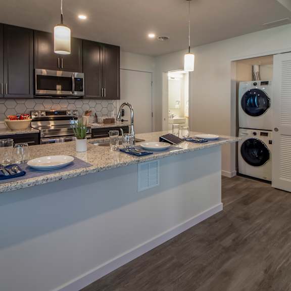 kitchen with a counter top and a washer and dryer in a house at reserve overlook apartments, integrity realty, cleveland heights, ohio