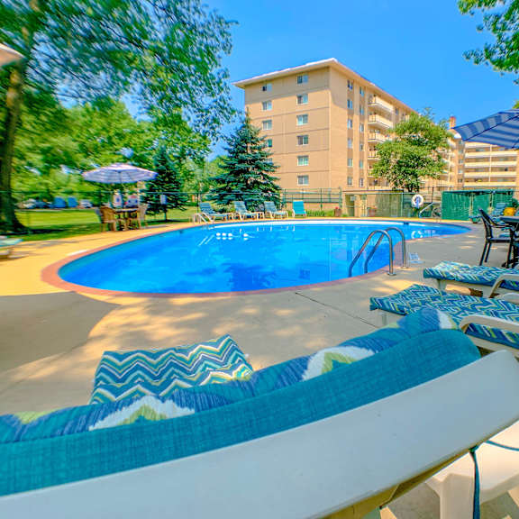 blue swimming pool with shaded lounge chairs at westwood meadows, westlake, oh, 44145