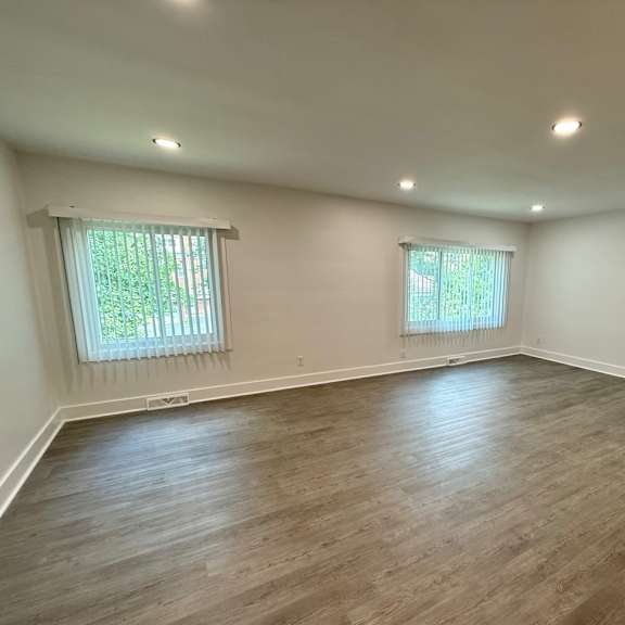 a room with wooden flooring and two windows old green place apartments, beachwood, oh