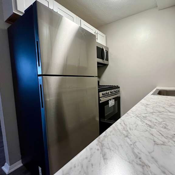 a kitchen with stainless steel appliances and a new counter top
