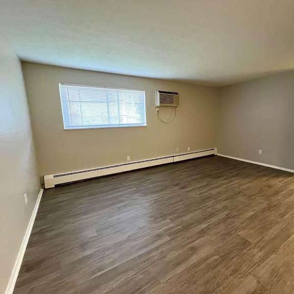 living room with plank style floors and a window