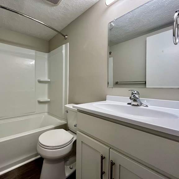a bathroom with a sink toilet and a tub