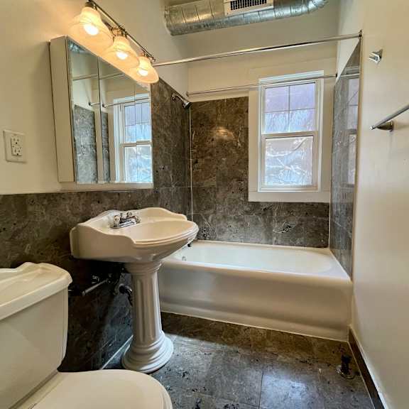 a bathroom with a sink toilet and a bath tub