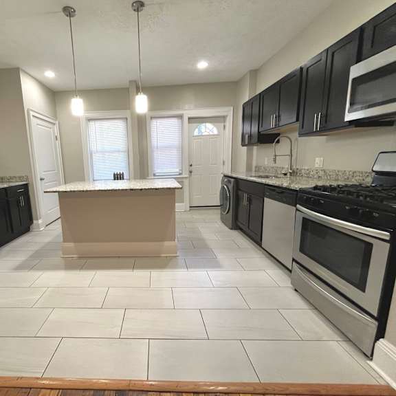 a kitchen with black appliances and white tiled floors at integrity cleveland heights apartments, apartments, cleveland heights, oh