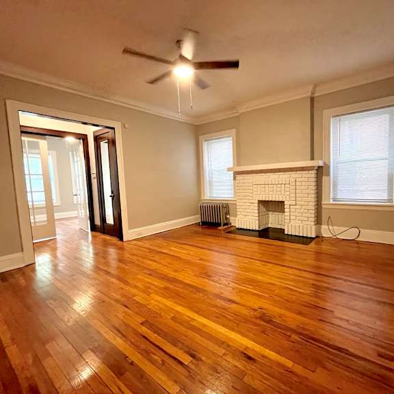 a room with a fireplace and wood flooring. at integrity cleveland heights apartments, ohio, 44106