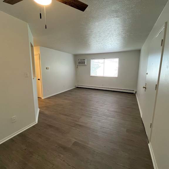 living room with plank style floors and a window