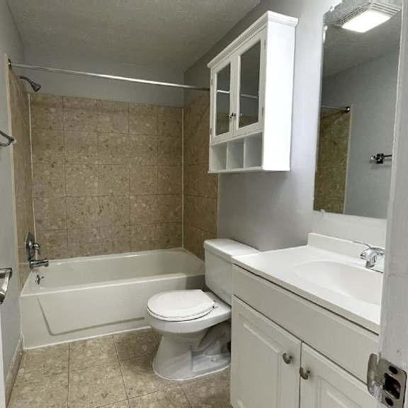 a bathroom with a toilet sink and bathtub