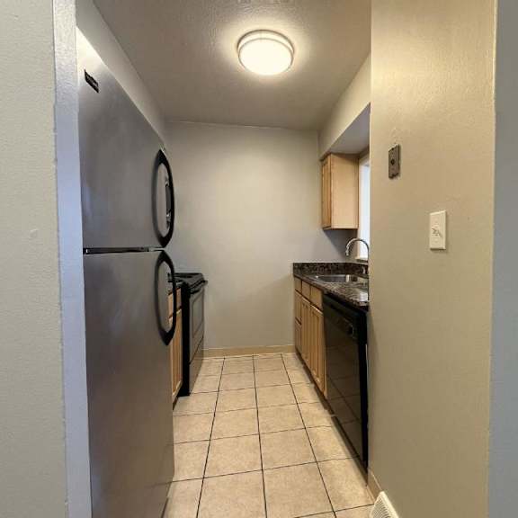 a kitchen with a refrigerator freezer and a sink