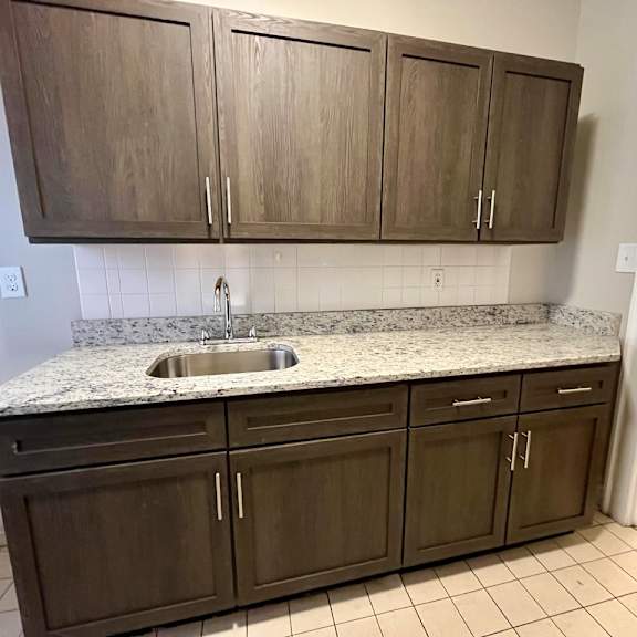 updated kitchen with espresso cabinets and granite countertops.