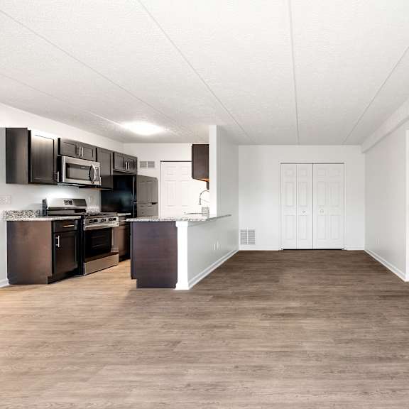a kitchen with dark brown cabinets and white walls at integrity medina apartments, medina, oh,  44256