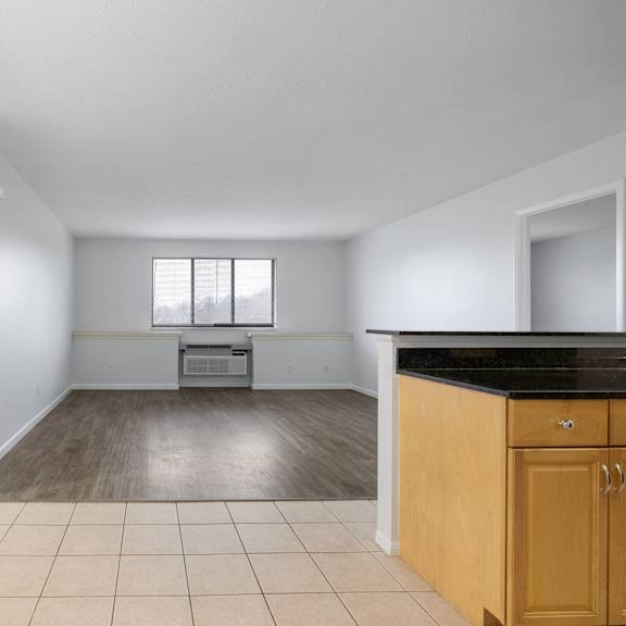 a kitchen area with a black countertop and wooden cabinets at integrity medina apartments, medina, oh,  44256