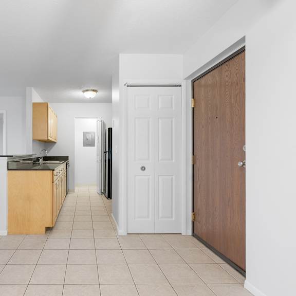a kitchen with white walls and a wooden door at integrity medina apartments, medina, oh,  44256