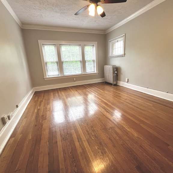 mapleview living room with hardwood floors and windows.