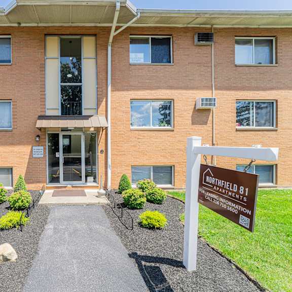 the image shows the front of a brick building with a sign that reads "northfield b1".