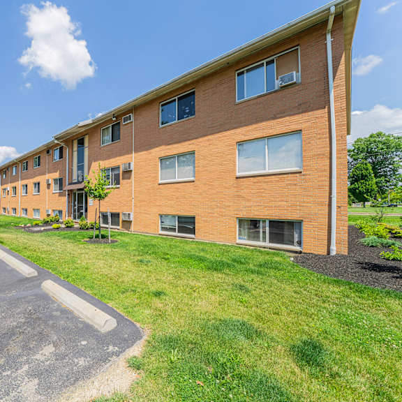 a long building with a grassy area in front.