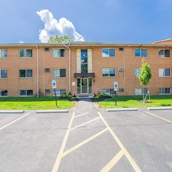 a large building with a parking lot in front of it.