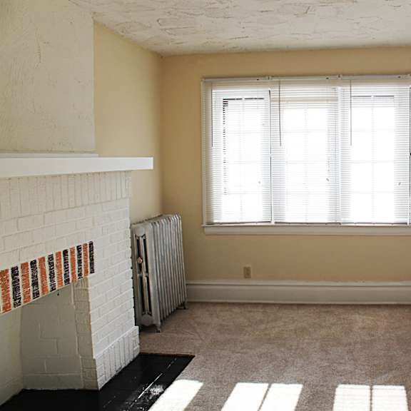 a room with a fireplace and a window.
