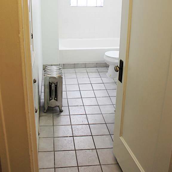 a white toilet is in a small bathroom.