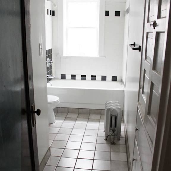 a white bathroom with a toilet and sink.