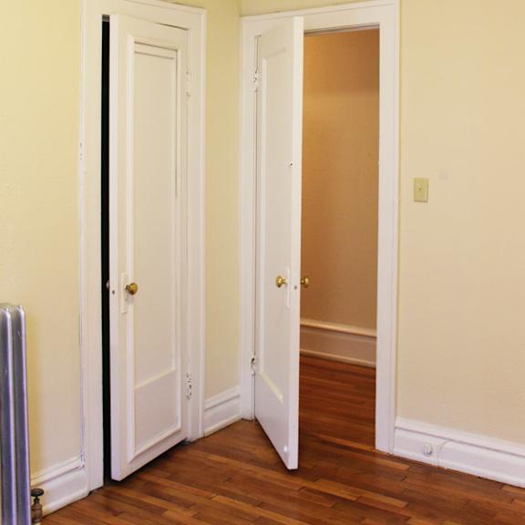 a room with a white door and a brown door.