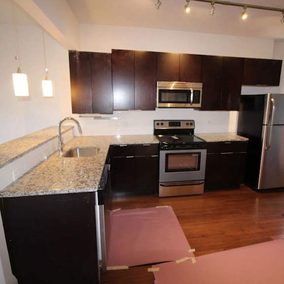 a kitchen with a granite counter top and stainless steel appliances.