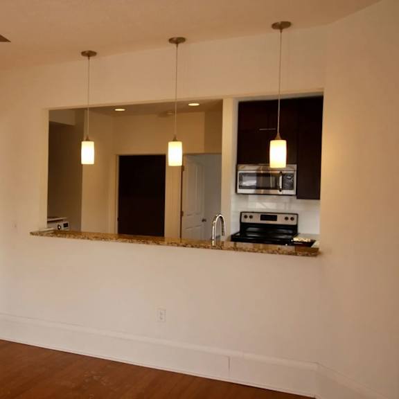 a modern kitchen with a large mirror above the counter.