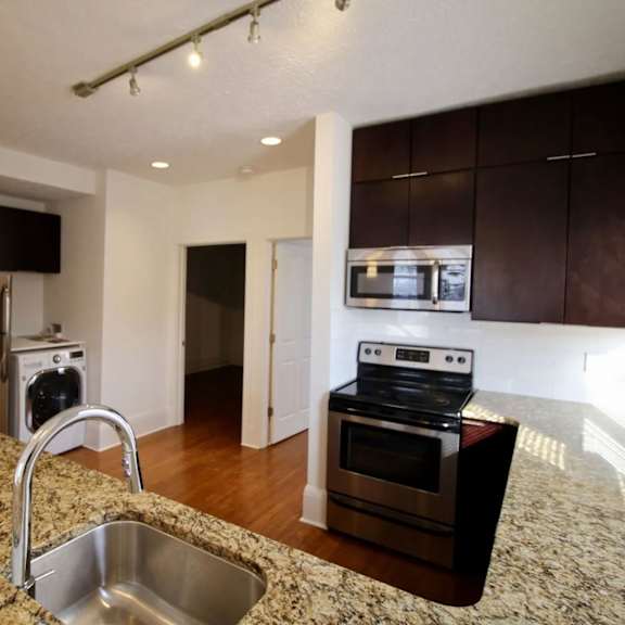 a kitchen with granite countertops and stainless steel appliances.