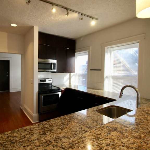 a kitchen with granite countertops and a sink.