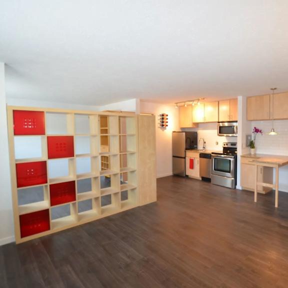 a kitchen with a red and white shelving unit.