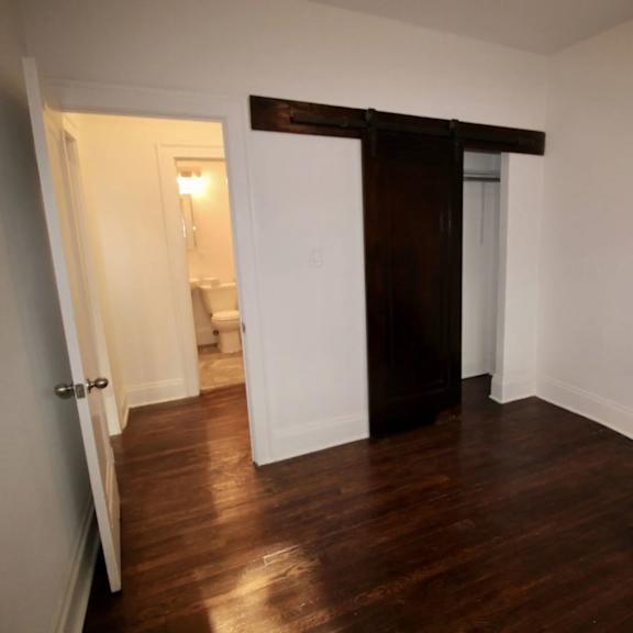 a room with a wooden floor and a white door.