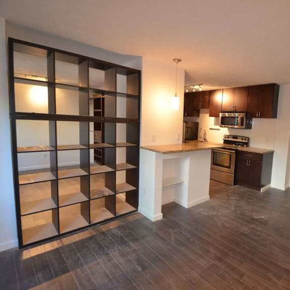 a kitchen with a white counter top and a white door.