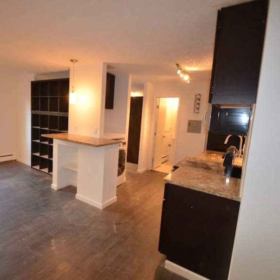 a kitchen with a white counter and black cabinets.