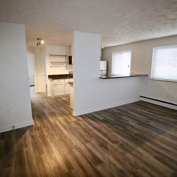 a room with wooden floors and white walls.
